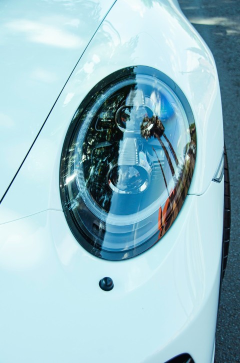 a close up of a cars headlight on a street