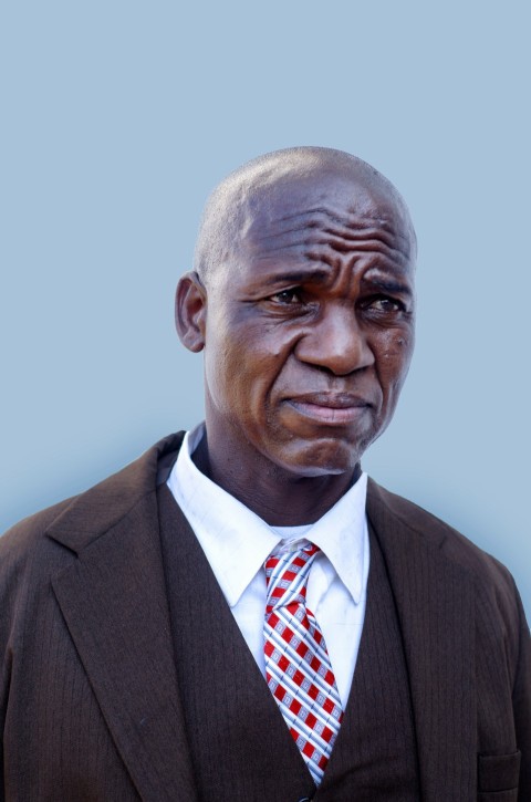 a man in a suit and tie with a serious look on his face