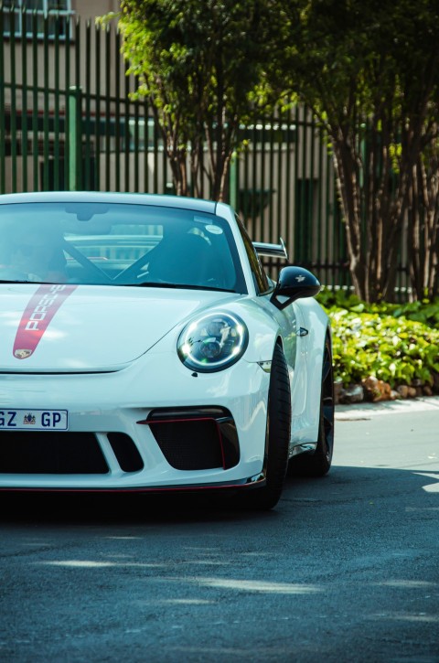 a white sports car parked on the side of the road