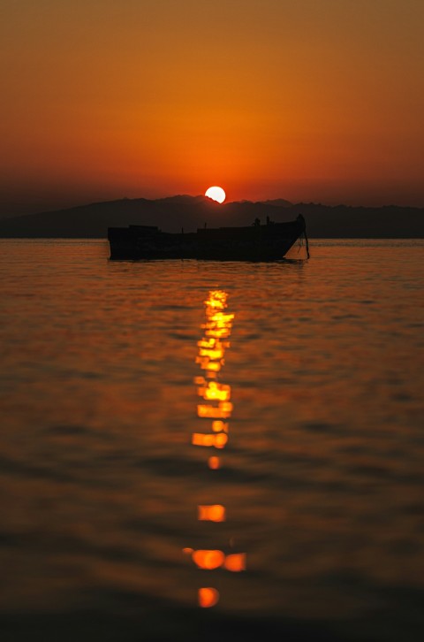 a boat floating on top of a large body of water