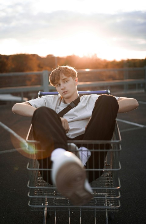 boy in black and white long sleeve shirt sitting on white metal chair