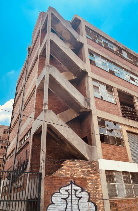 a tall brick building with graffiti on the side of it