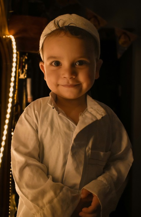 a little boy that is wearing a white shirt