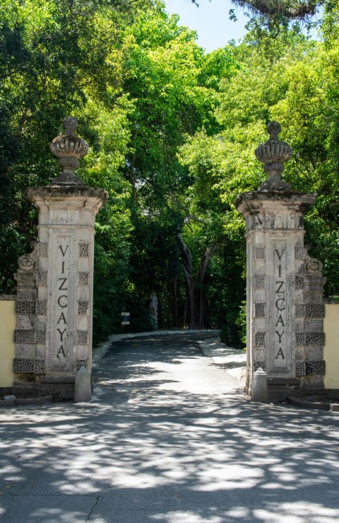 a couple of gates that are on the side of a road