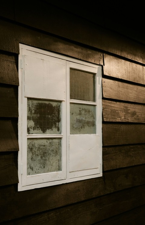 a window on the side of a wooden building