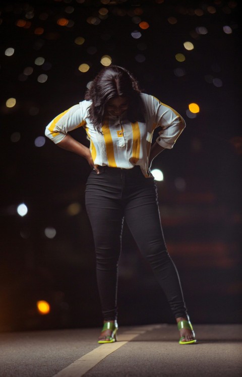 a woman standing on a stage with her hands on her hips