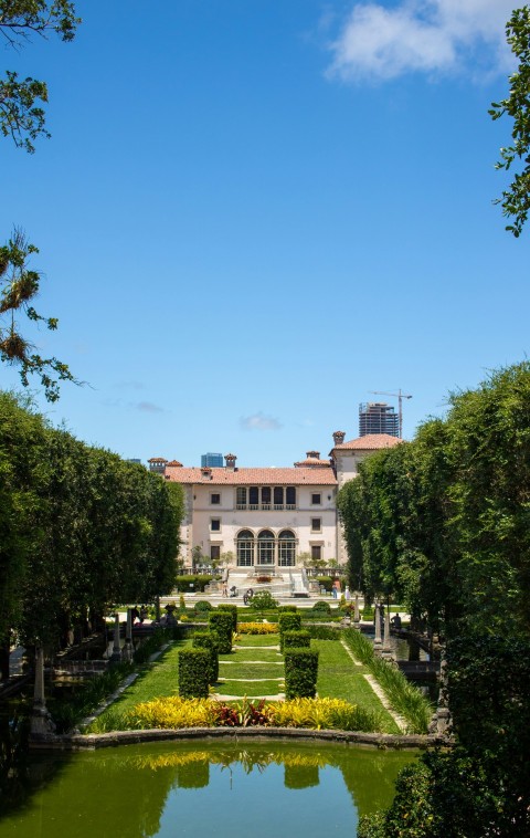 a view of a building from across a pond