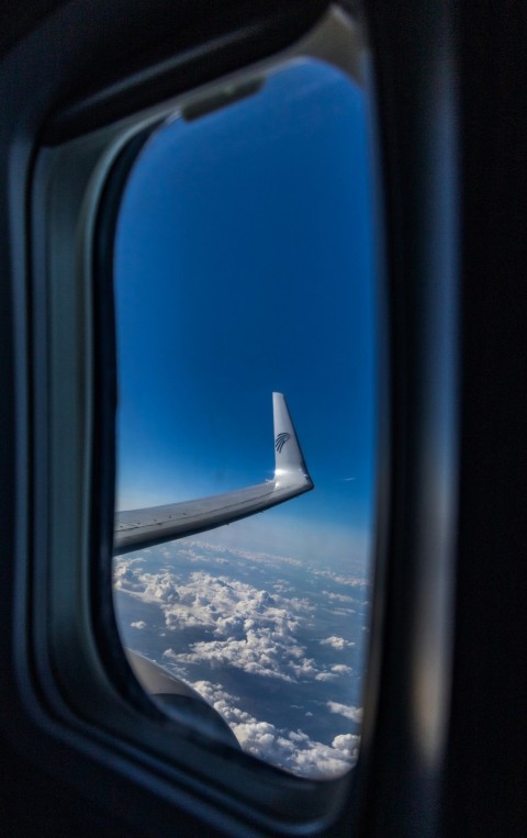 a view of the wing of an airplane through a window