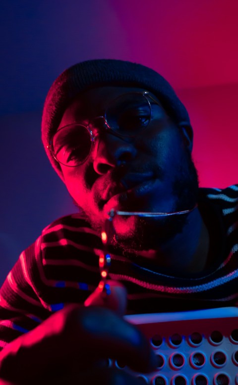 man wearing sunglasses showing necklace