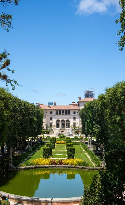 a large building with a garden in front of it 22x