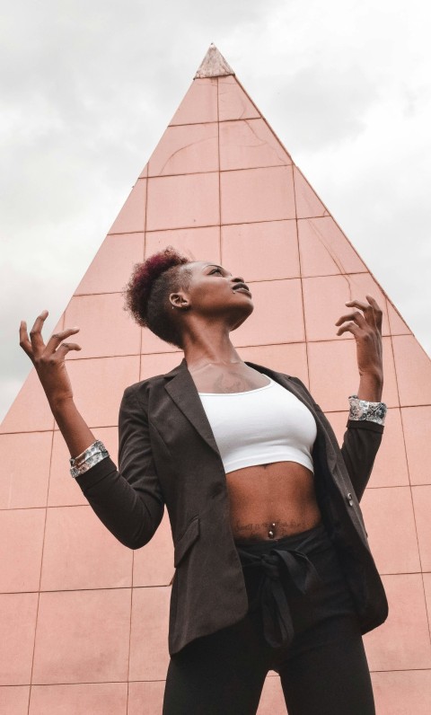 woman in black blazer standing and smiling 6r