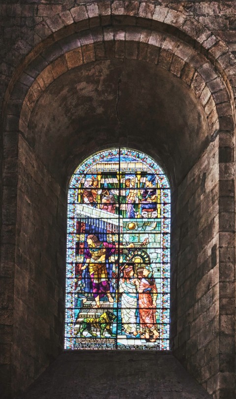 a large stained glass window in a stone building 3T5B