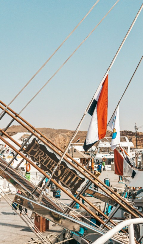 white and brown sail boat on body of water during daytime