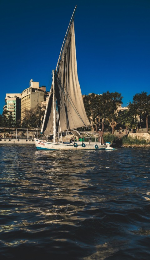 a sailboat sailing on a body of water