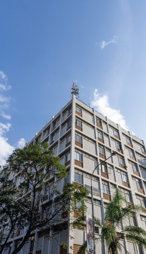 a tall building with trees in front of it