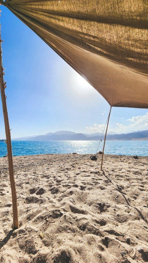 a view of the ocean from a sandy beach