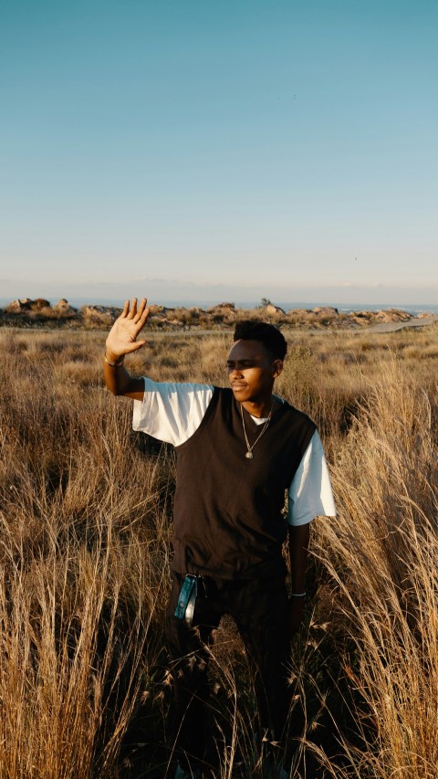 a man standing in a field of tall grass