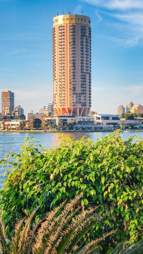 a tall building next to a body of water