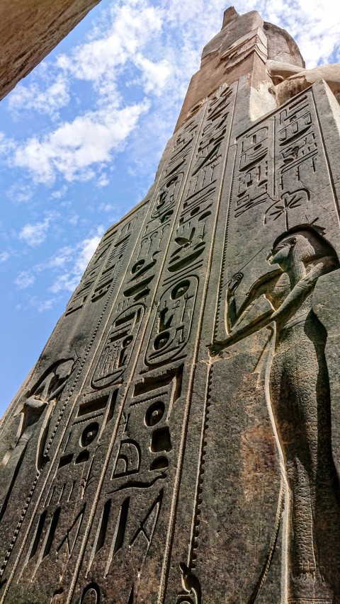 a tall stone tower with egyptian writing on it