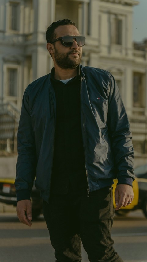 a man in a black shirt and a blue jacket