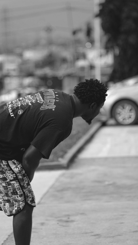 a man riding a skateboard down a sidewalk