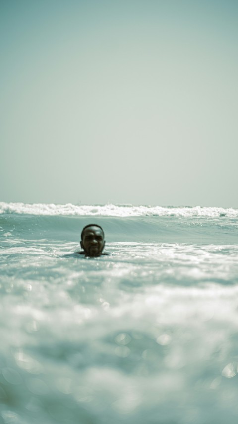 a person swimming in the ocean on a sunny day