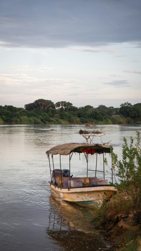 a small boat floating on top of a river