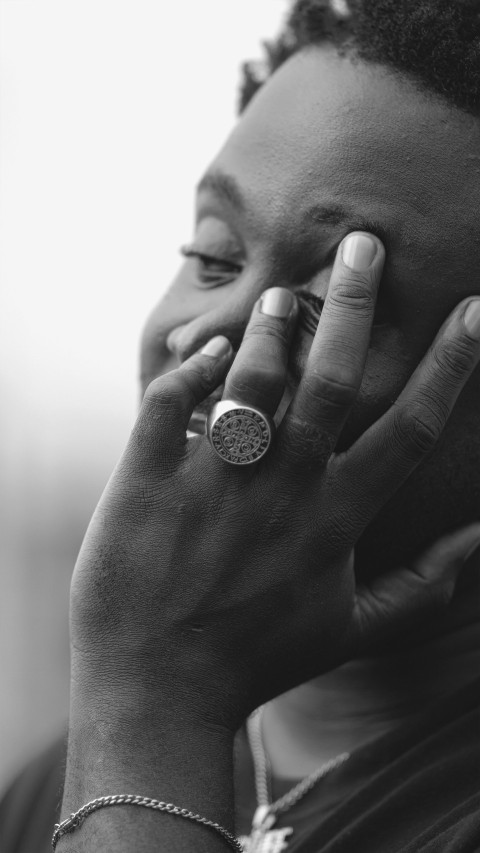 a woman talking on a cell phone while wearing a ring