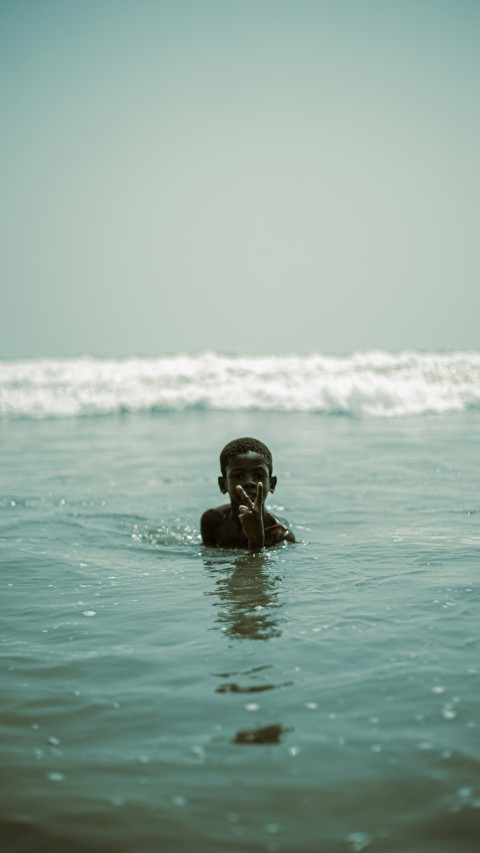 a man swimming in the ocean with his head above the water