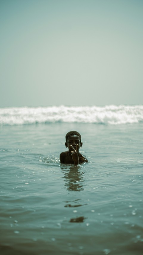 a man swimming in the ocean with his head above the water