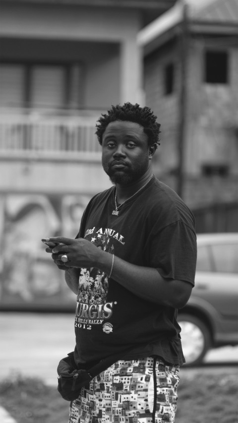 a man standing in front of a building holding a cell phone