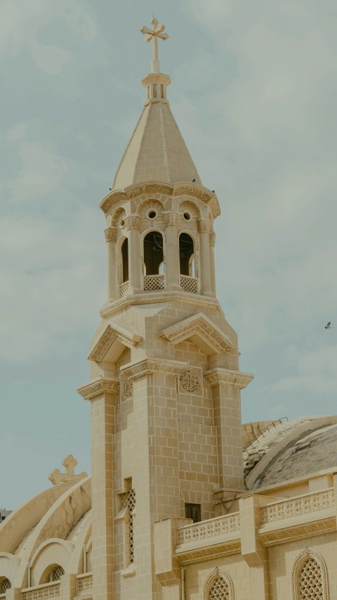 a large white building with a cross on the top of it