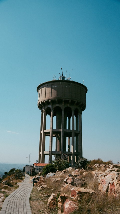 a large water tower sitting on top of a hill 9h4nXXCCF