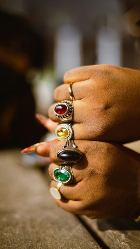 a close up of a persons hand holding a ring