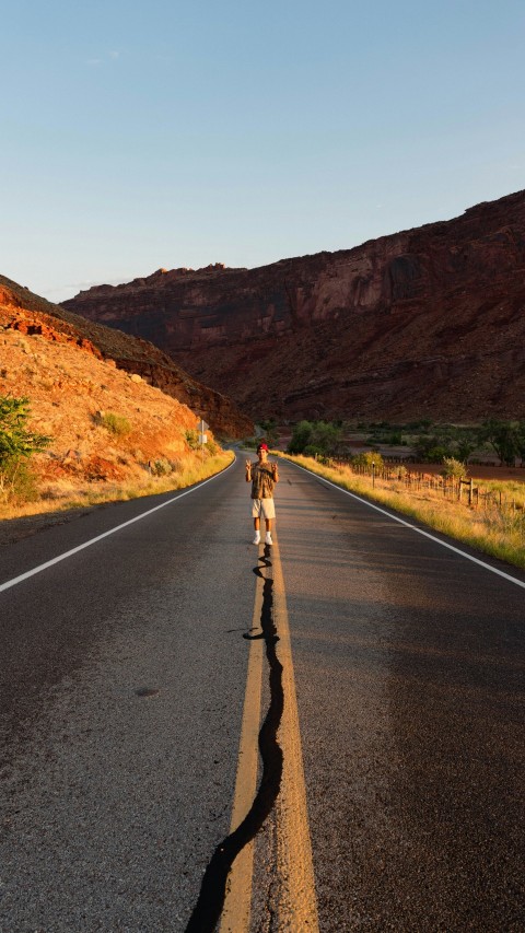 a couple of people that are walking down a road p7SN9 q