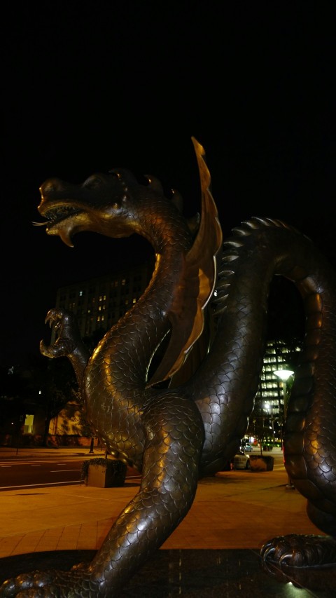 a statue of a dragon in front of a building