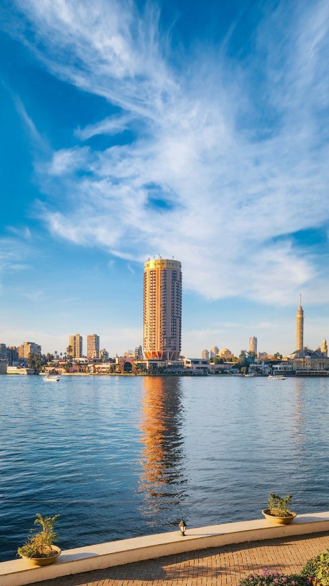 a body of water with a city in the background