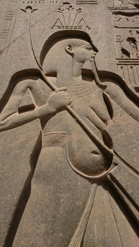 a large stone carving of an egyptian god