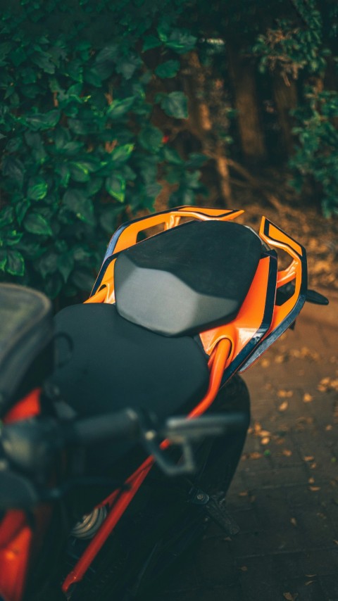 a close up of a motorcycle parked near a bush