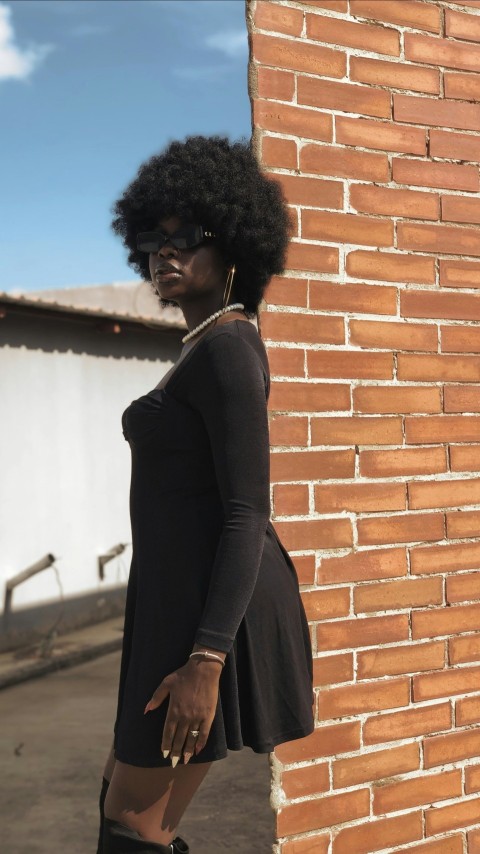 a woman standing next to a brick wall F2BW