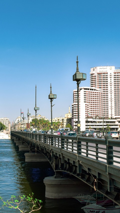 white and brown concrete building near body of water during daytime