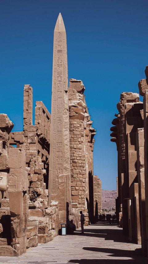 a tall stone tower with karnak in the background P72S