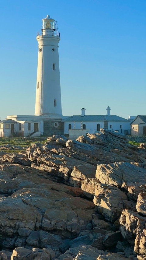 a lighthouse on a rocky hill