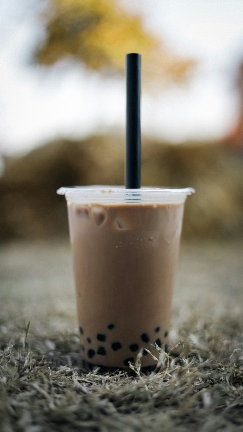 a plastic cup with a black straw sticking out of it