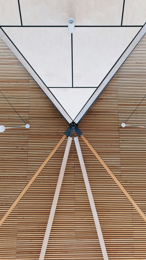 a close up of a wooden floor with a skylight