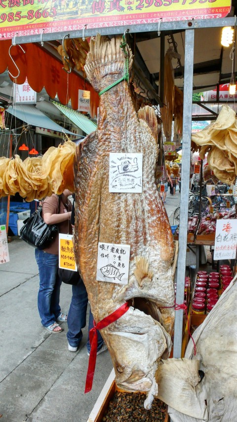 a person standing in front of a food stand