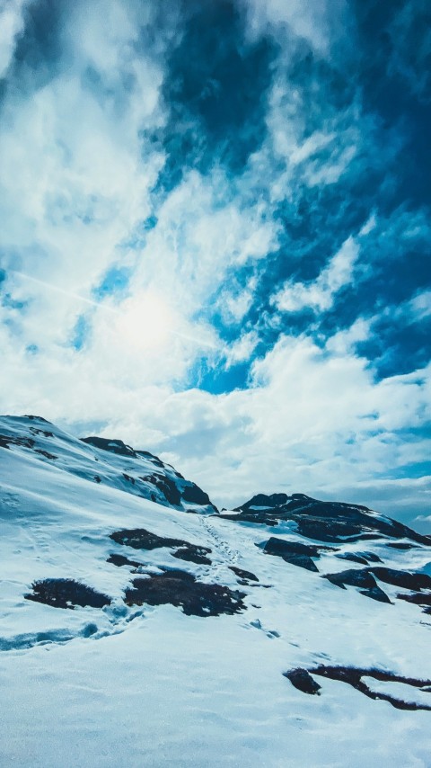 a man riding skis on top of a snow covered slope