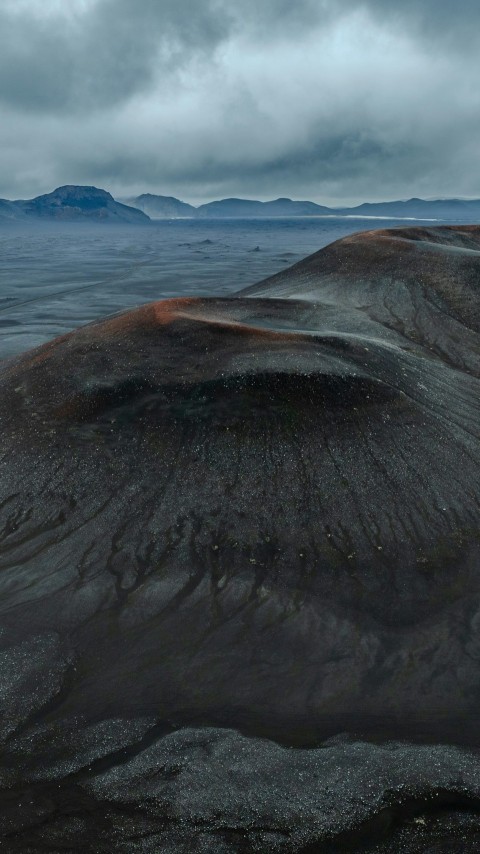 a very large hill with some very pretty mountains in the background