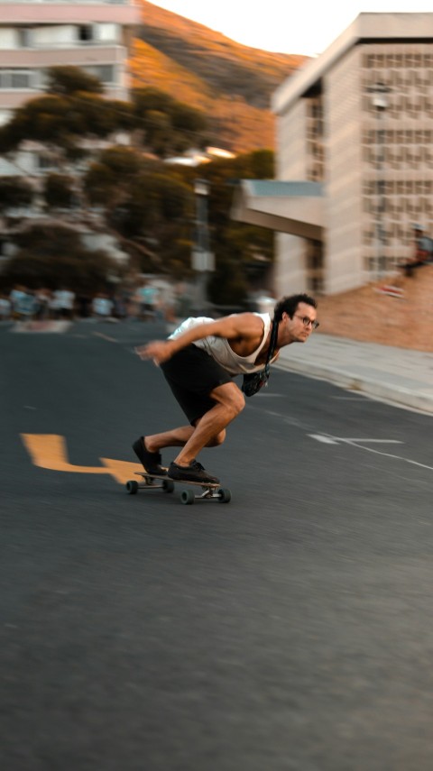 a man riding a skateboard down a street