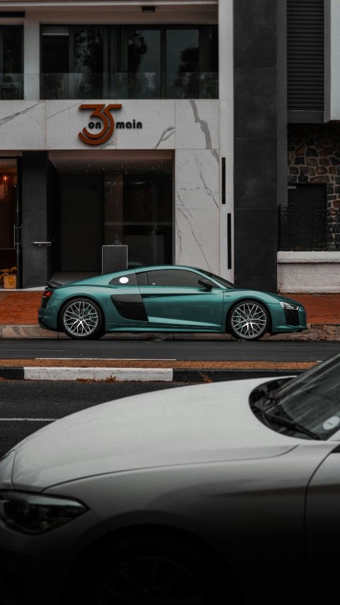 a car parked on the side of the road in front of a building